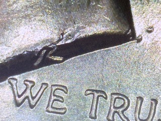 2025 Kennedy Half Dollar die crack error showing raised line of metal across coin surface caused by a cracked die